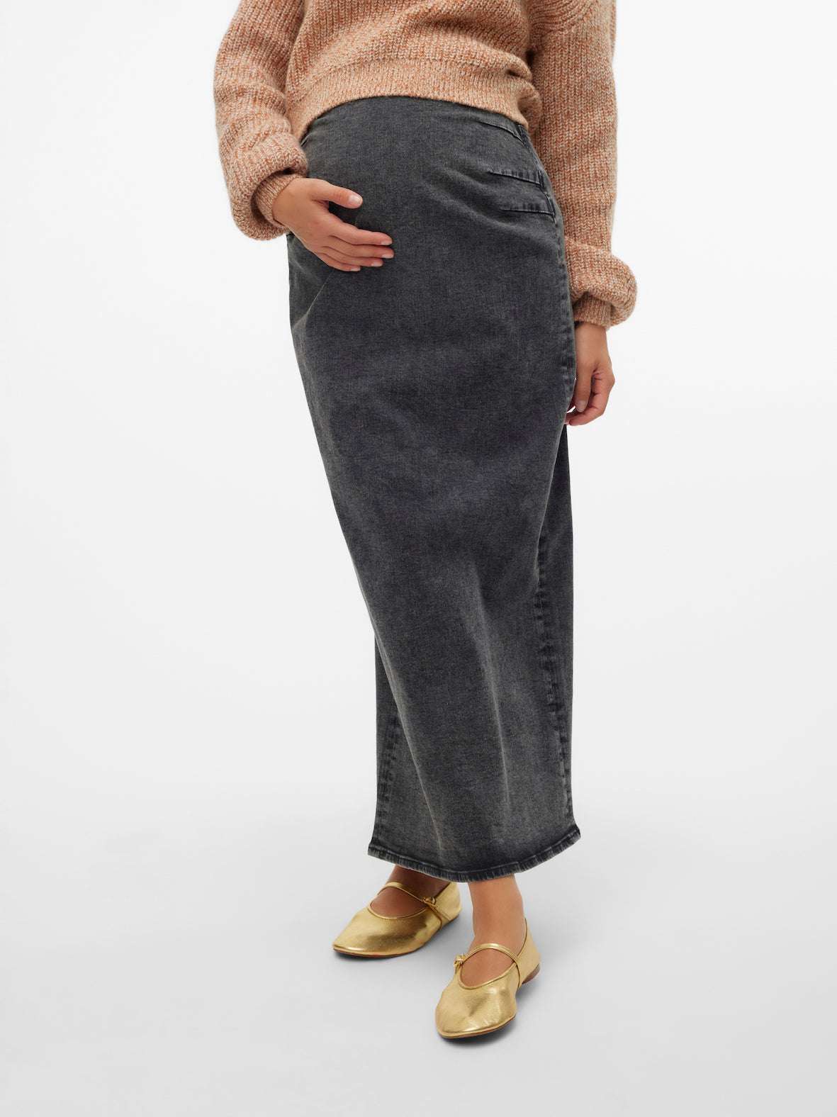 Model trägt ein Mamalicious Maxi Jeansrock für die Schwangerschaft in frontaler Ansicht. Im Mutterkleid Online Shop erhältlich.