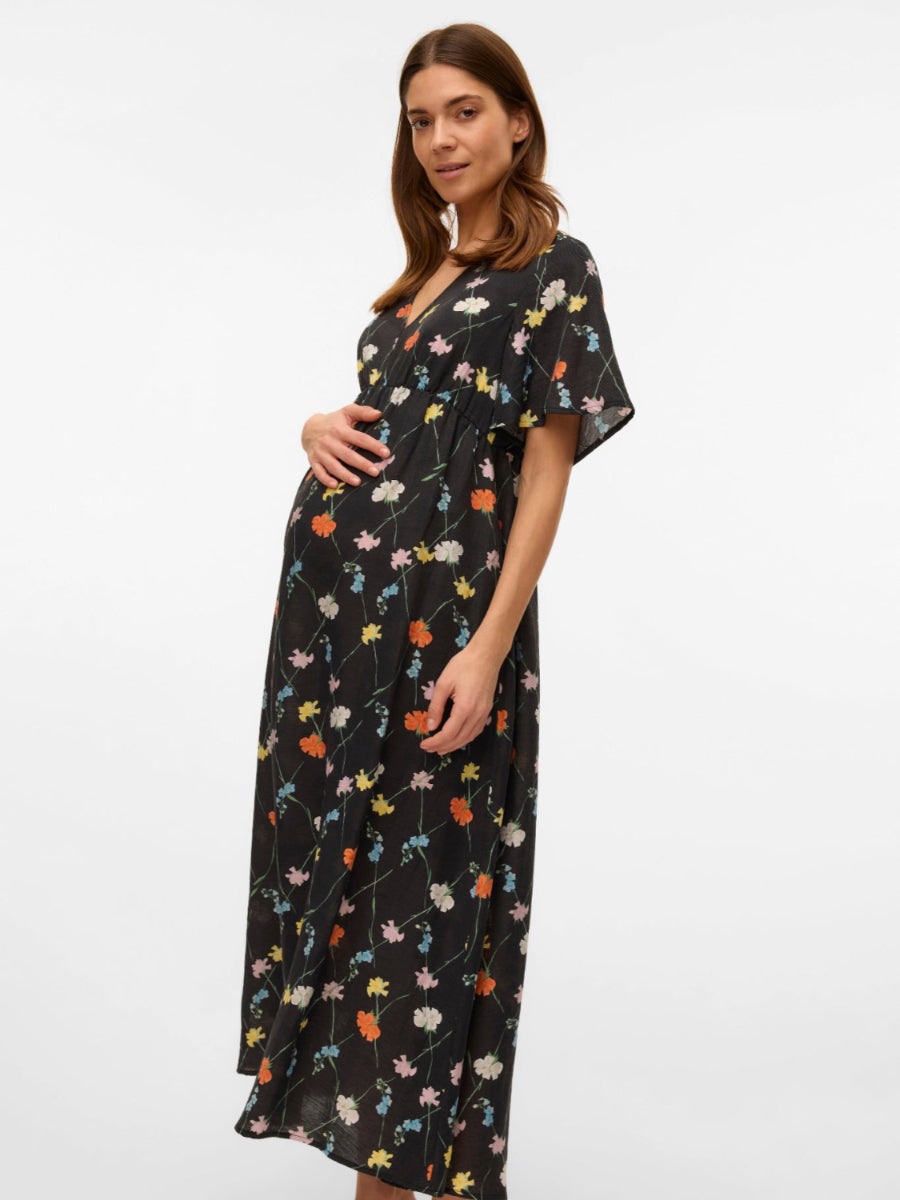 Seitenansicht Umstanskleid mit Blumenmuster. Miete oder kaufe bei Mutterkleid